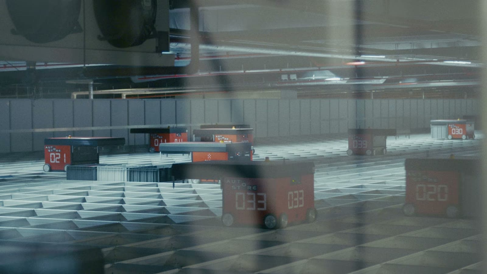 Robots moving bins across an automated warehouse grid