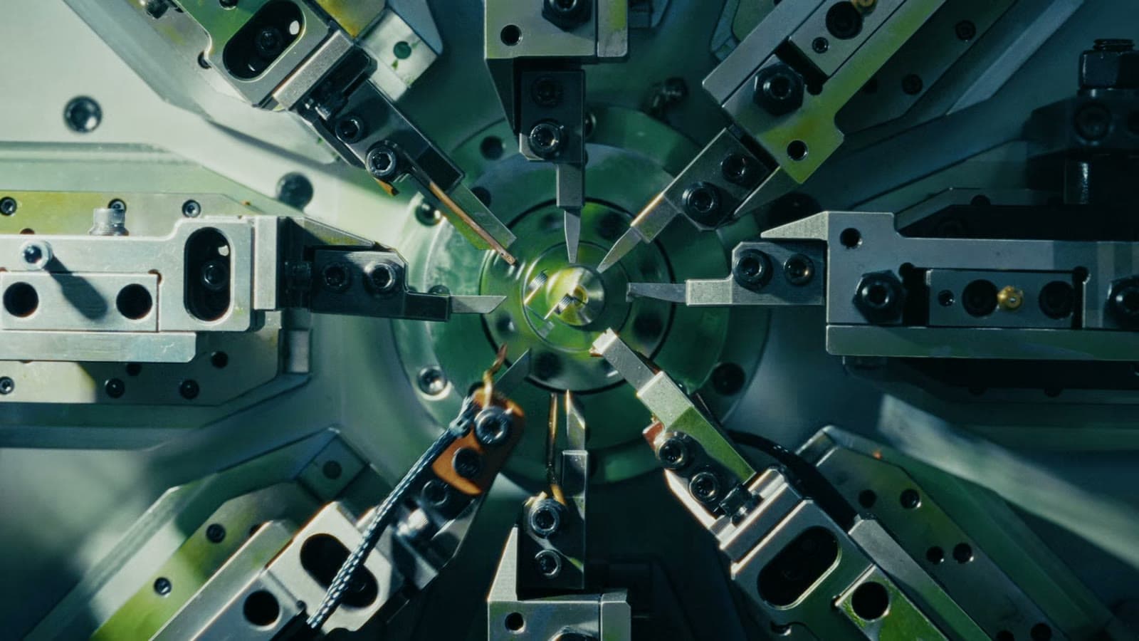 Tooling closing in on a part inside a machine